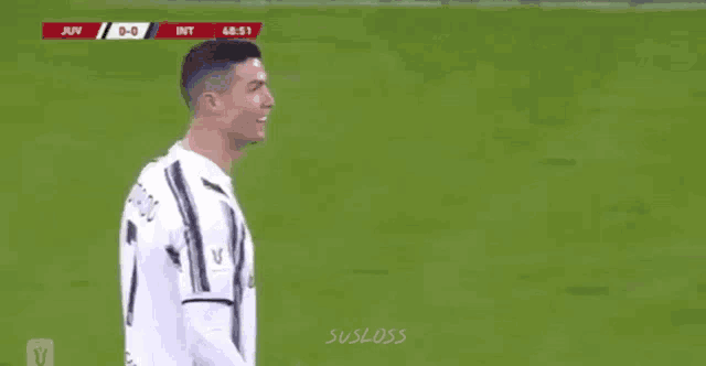 a soccer player is standing on a soccer field .