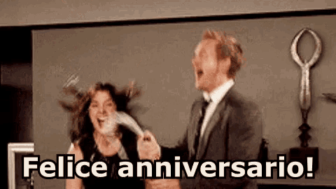 a man in a suit and tie is holding a woman 's hair and saying felice anniversario