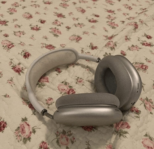 a pair of headphones are laying on a floral quilt