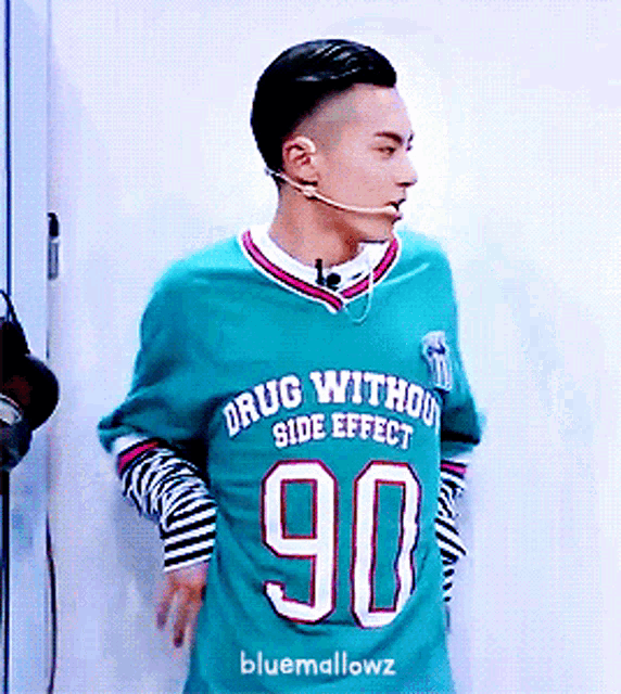 a man wearing a blue shirt that says drug without side effect