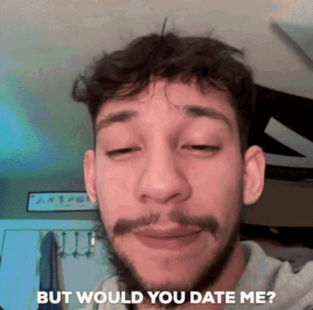 a man with a beard is taking a selfie with the words `` but would you date me ? ''