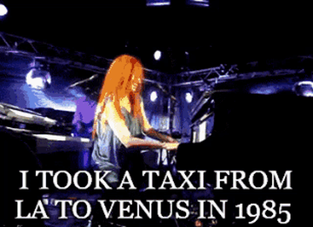 a woman singing into a microphone with the words " i took a taxi from la to venus in 1985 " above her