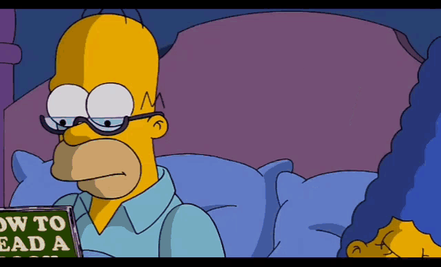 homer simpson is reading a book about how to read