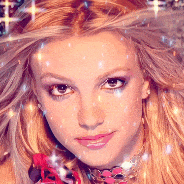 a close up of britney spears ' face with sparkles coming out of her hair