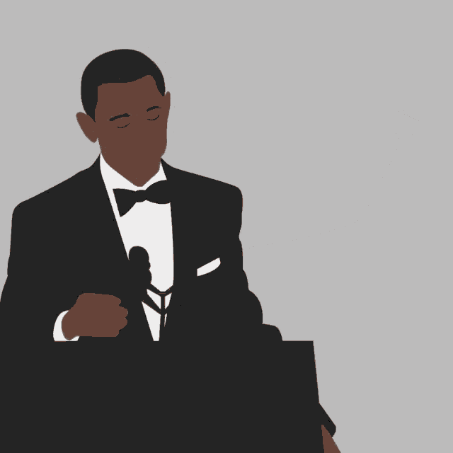 a man in a suit and tie stands at a podium with his hand on his mouth