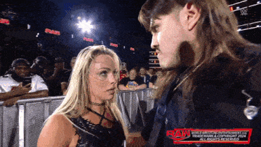 a man and a woman are standing next to each other with the word raw on the bottom right