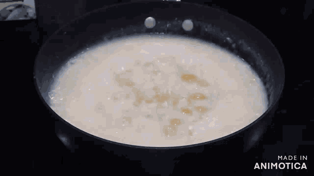 a pan of rice is being cooked and made in animatica