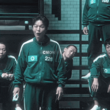 a man in a green uniform has the number 226 on his jacket