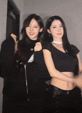 two women are posing for a picture and one has a choker on