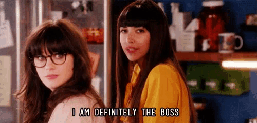 two women are standing next to each other in a kitchen and one of them is talking about being the boss .