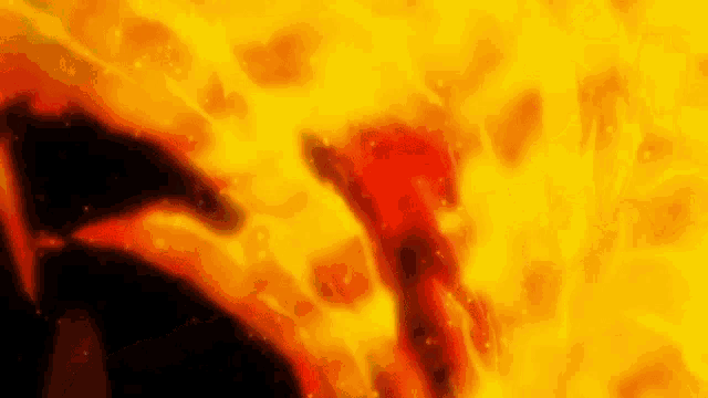 a close up of a person in a fire with a lot of flames coming out of it .