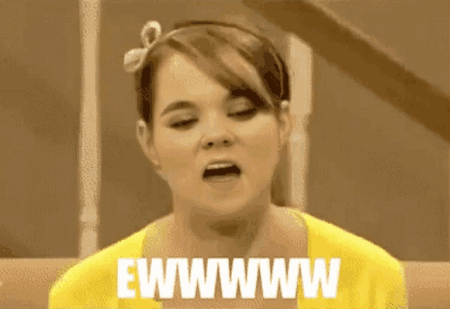 a woman in a yellow sweater is making a funny face and says ewwwwww .