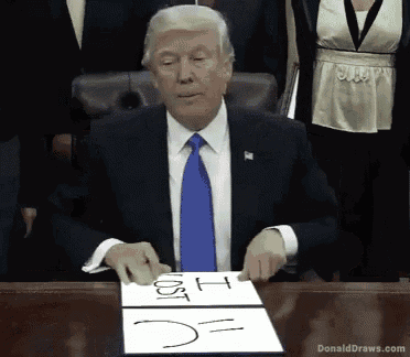 donald trump sitting at a desk with a piece of paper that says cost