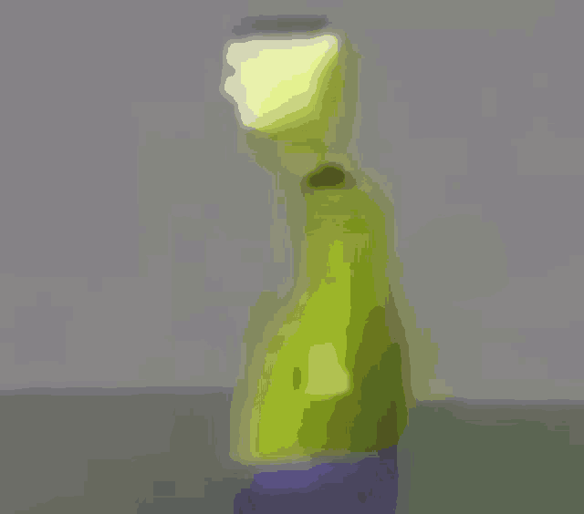 a blurry picture of a cartoon character in a green jacket and blue pants .