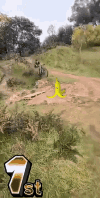 a picture of a person riding a bike with a banana on the ground