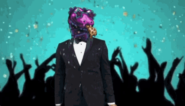 a man in a tuxedo has a balloon on his head