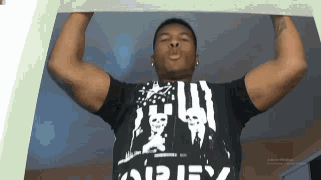 a man wearing a black shirt with the word apex on the front
