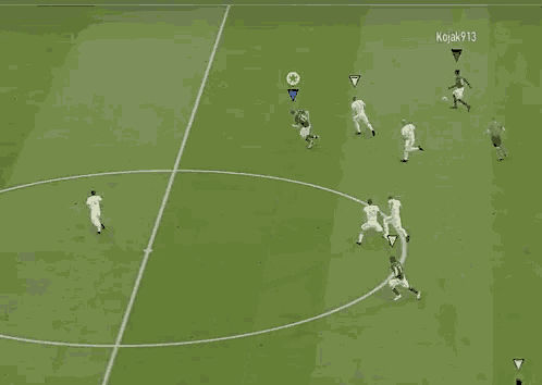 a soccer game is being played on a field with a yellow circle in the middle
