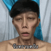 a man without a shirt is making a funny face with a blue and white curtain behind him