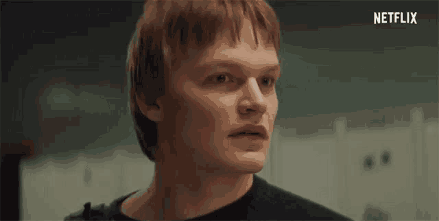 a close up of a man 's face in a locker room with a netflix logo in the background .