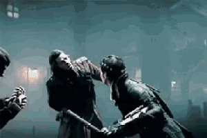 a man is fighting another man with a bat in a dark room .