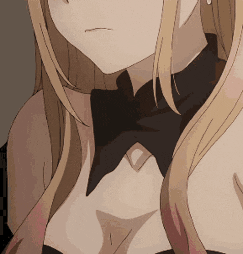 a close up of a woman 's chest with a black bow tie
