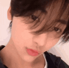a close up of a person 's face with a fringe .