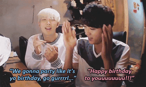 two young men are sitting at a table and one of them is saying " we gonna party like it 's yo birthday go gurrrrl "