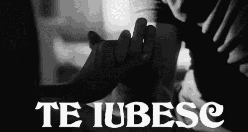 a black and white photo of a person holding another person 's hand with the words te iubesc written below them