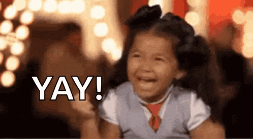 a little girl is laughing and saying yay !