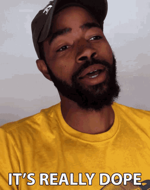 a man with a beard is wearing a yellow shirt that says " it 's really dope "