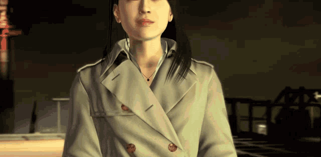 a woman wearing a trench coat and a necklace stands in a dark room