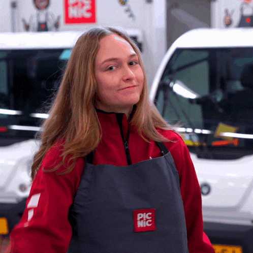 a woman wearing a red jacket and an apron that says pic nic on it