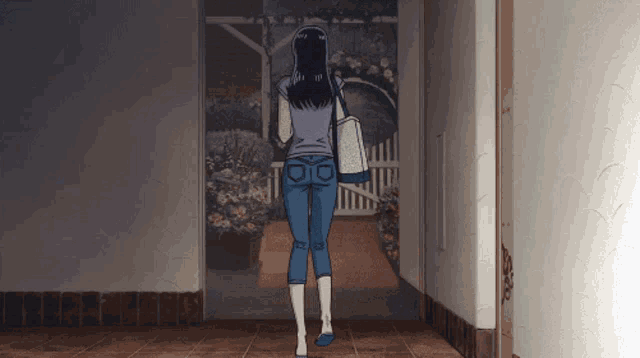 a woman is walking down a hallway with a bag on her shoulder and the letter d on her jeans