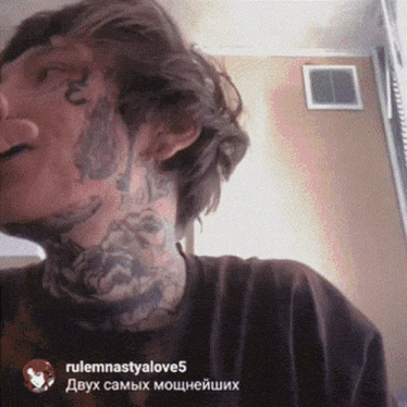 a man with a lot of tattoos on his face has rulemnastyalove5 written on the bottom right