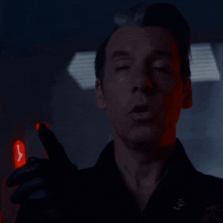 a close up of a man 's face with a red light behind him that says ' nyc '