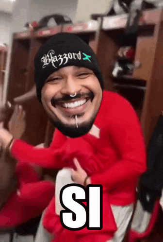 a man wearing a beanie that says blazzard on it is smiling