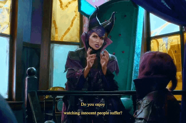 a woman in a witch costume says do you enjoy watching innocent people suffer while standing in front of a window