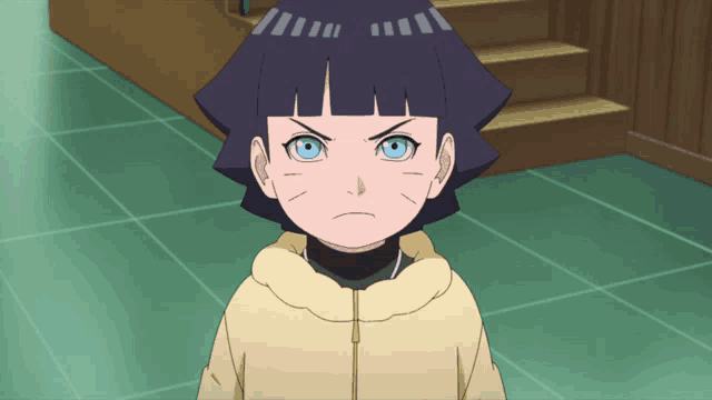 a little girl with a yellow jacket and blue eyes looks angry