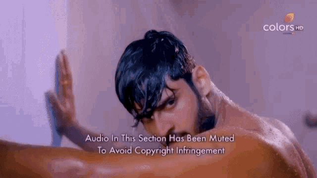 a man is taking a shower with the words audio in this section has been muted to avoid copyright infringement below him
