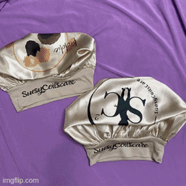 two satin hats with suesy collscare printed on them