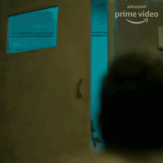 a man is standing in front of a door that says amazon prime video
