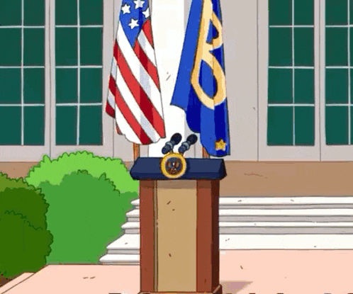 a podium with an american flag and a blue flag with the letter b on it