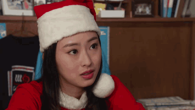 a woman is wearing a santa hat and a red shirt