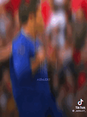 a soccer player wearing a blue shirt that says ' atl ' on it