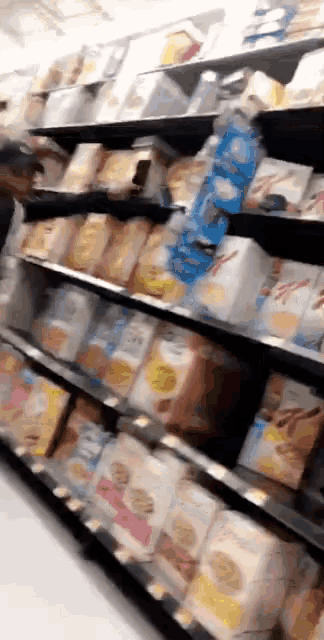 a blurred image of a grocery store aisle filled with various items