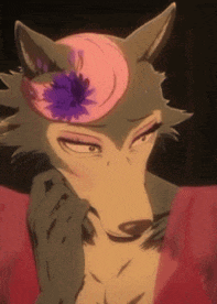 a close up of a wolf with a pink flower on her head .