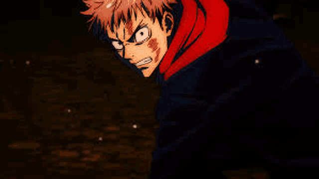 a close up of a person 's face with a red hoodie on .