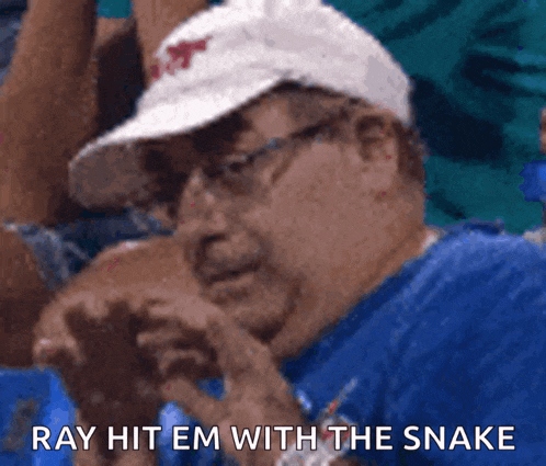a man wearing a white hat and glasses says " ray hit em with the snake "