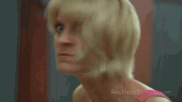 a close up of a woman 's face with the website recklesstoruga.com visible